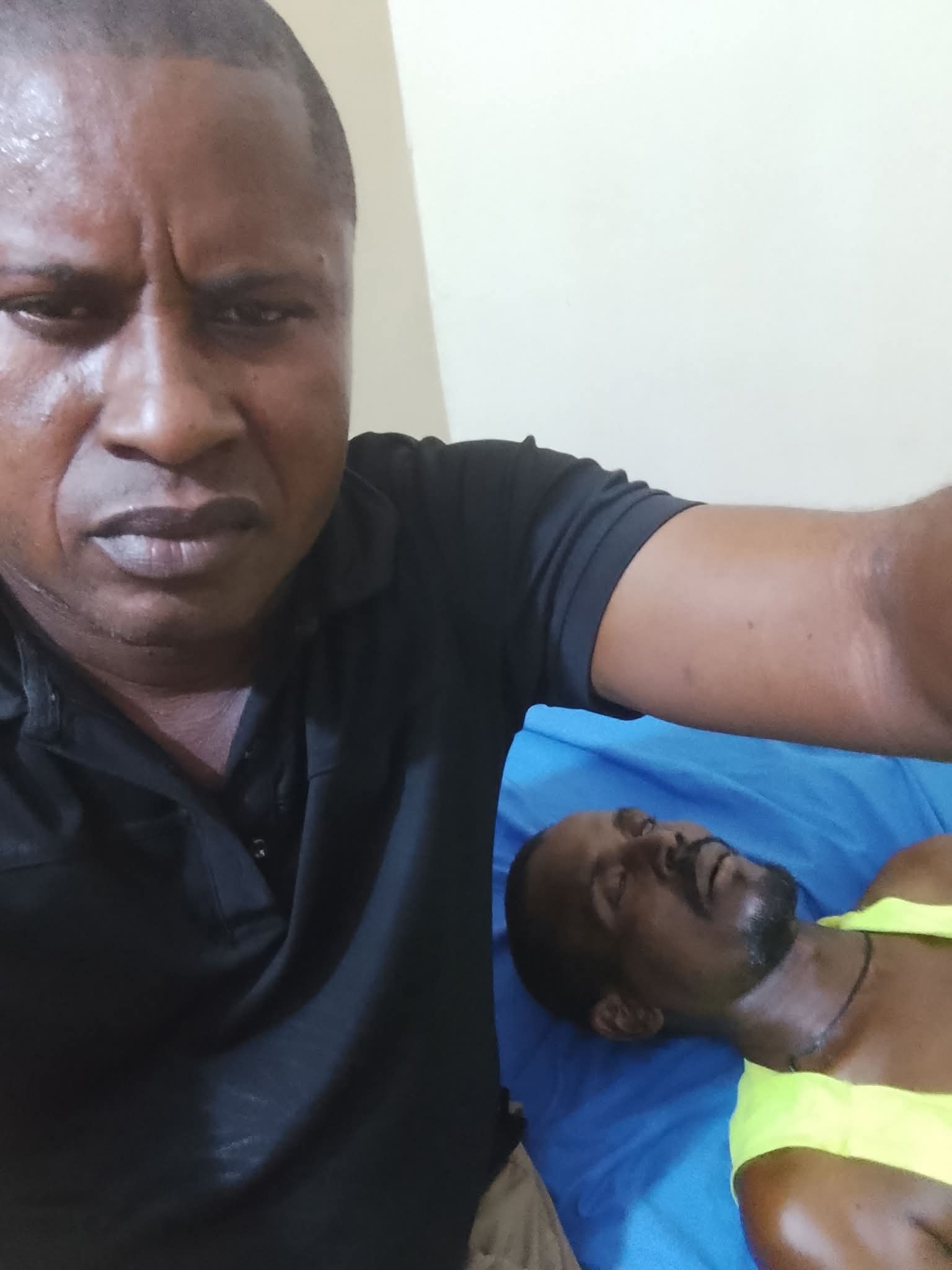 Sad: Nigerian Man mourns his brother. 